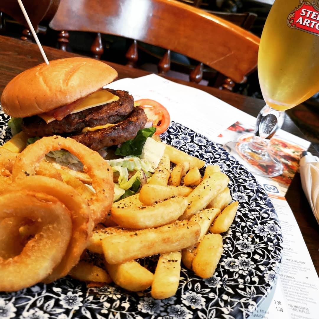  - How do you like your empire state burger? On a dry bun, half a slice of bacon, a slice of hard cheese, cold onion rings and chips.